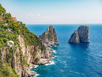 Panoramic view of rocks in sea against sky