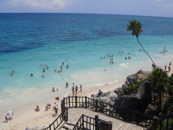 Panoramic view of people on beach against clear sky