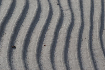 High angle view of tire tracks on sand