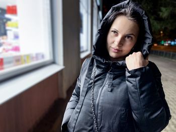 Portrait of young woman standing outdoors