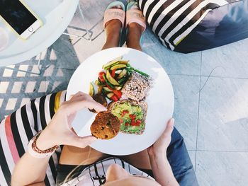 High angle view of woman holding food plate