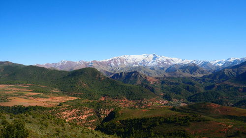 Scenic view of mountains against clear blue sky