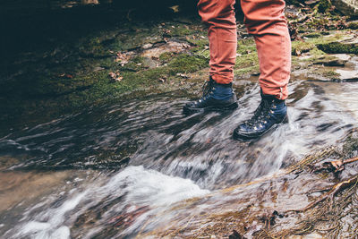 Low section of man standing on rock