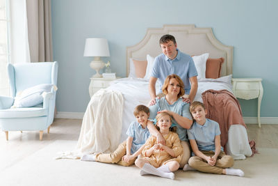 Portrait large family five people father mother two sons and daughter lying