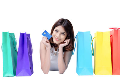 Portrait of smiling young woman against white background