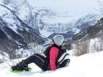 Full length of woman on snowcapped mountain against sky