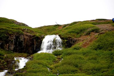 Scenic view of waterfall against clear sky