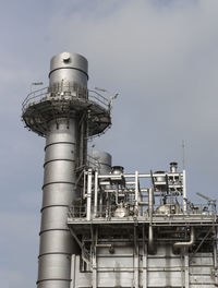 Low angle view of smoke stack against sky