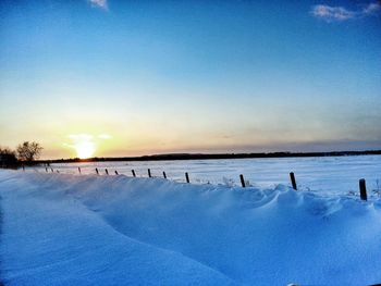 Scenic view of snow covered landscape against sky