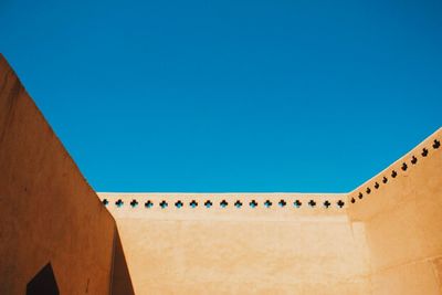 Low angle view of building against blue sky