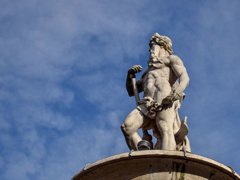 Low angle view of statue against sky