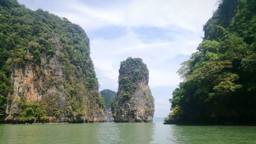 Panoramic shot of sea by cliff against sky
