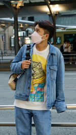 Young man standing in city