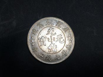 Close-up of coin against black background