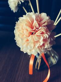 Close-up of artificial flower on wooden table