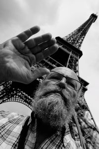 Low angle view of senior man against eiffel tower