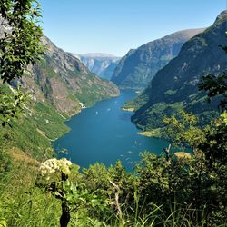 Scenic view of lake and mountains against clear sky