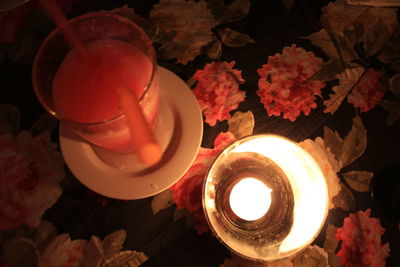 High angle view of lit tea light candles