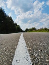 Road amidst trees against sky