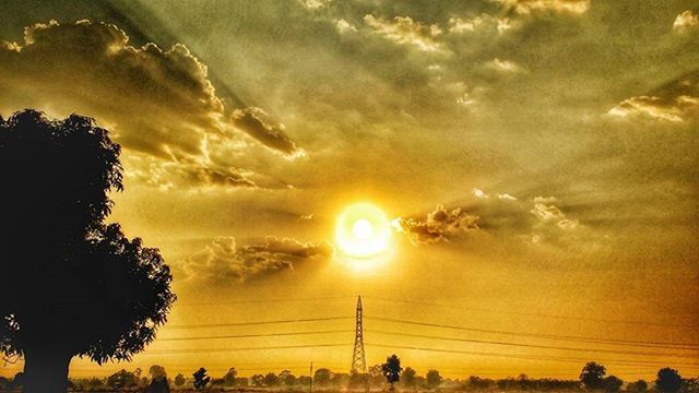 sunset, sky, silhouette, beauty in nature, scenics, tranquility, tranquil scene, cloud - sky, orange color, tree, nature, landscape, power line, idyllic, cloud, sun, dramatic sky, electricity pylon, cloudy, outdoors