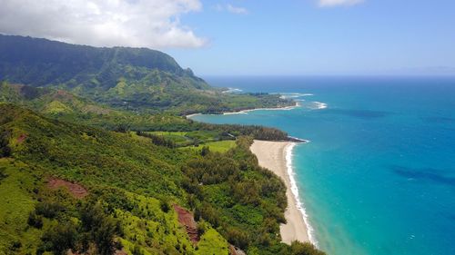 Scenic view of sea and mountains against sky