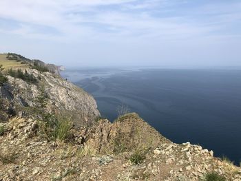 Scenic view of sea and mountains against sky