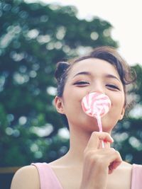 Portrait of woman holding lollipop