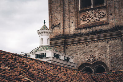 Low angle view of bell tower against sky