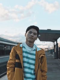 Portrait of young man standing at platform