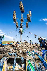 Low angle view of fishing net against blue sky