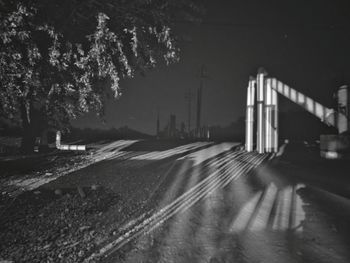 Empty road along trees