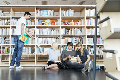 Young male and female student in university library