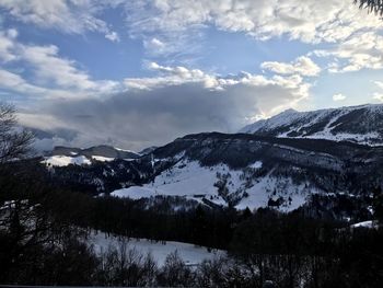Scenic view of snowcapped mountains against sky