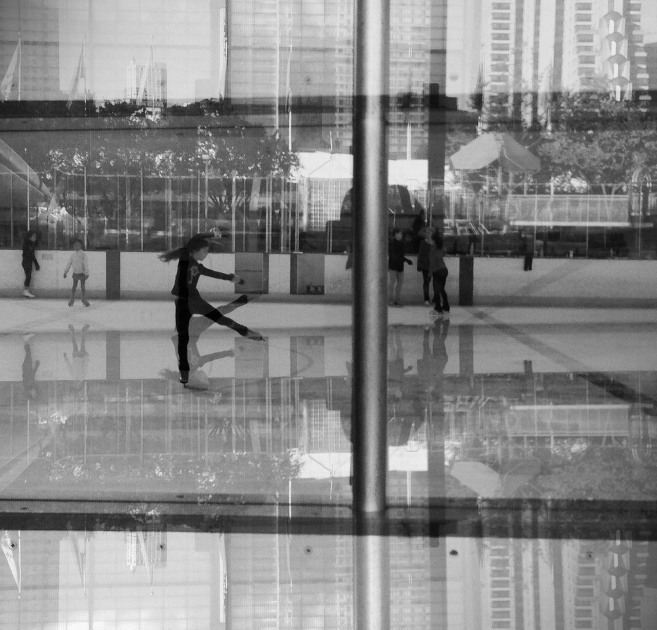 indoors, lifestyles, glass - material, men, person, transparent, reflection, architecture, walking, built structure, leisure activity, window, modern, standing, city, full length, city life, building exterior