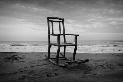 Lifeguard hut on beach against sky