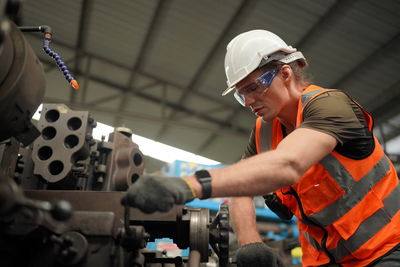 Portrait of male worker standing in the heavy industry manufacturing factory.