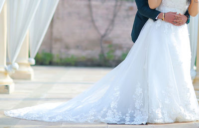 Rear view of mother and daughter standing outdoors