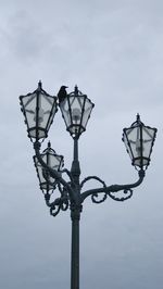 Low angle view of street light against sky