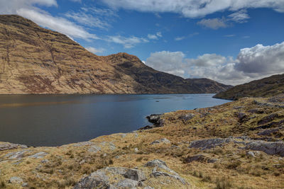 Scenic view of lake and mountains against sky