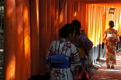 Rear view of woman walking at temple