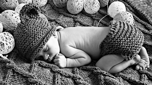 High angle view of baby boy sleeping on bed