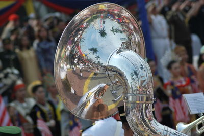 Close-up of sousaphone against people during celebration