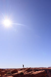 Man against clear sky on sunny day