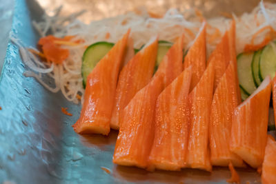 Close-up of orange fish in plate
