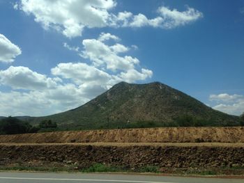 Scenic view of mountains against cloudy sky