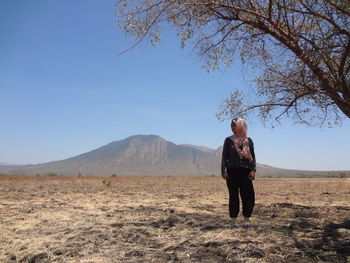 Full length of man standing on land against sky