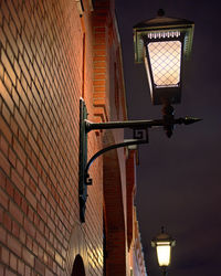 Low angle view of illuminated street light at night