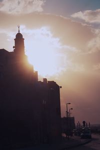 Silhouette buildings against sky during sunset