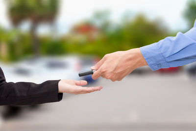 Close-up of hand holding cigarette