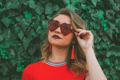 Portrait of young woman wearing sunglasses outdoors